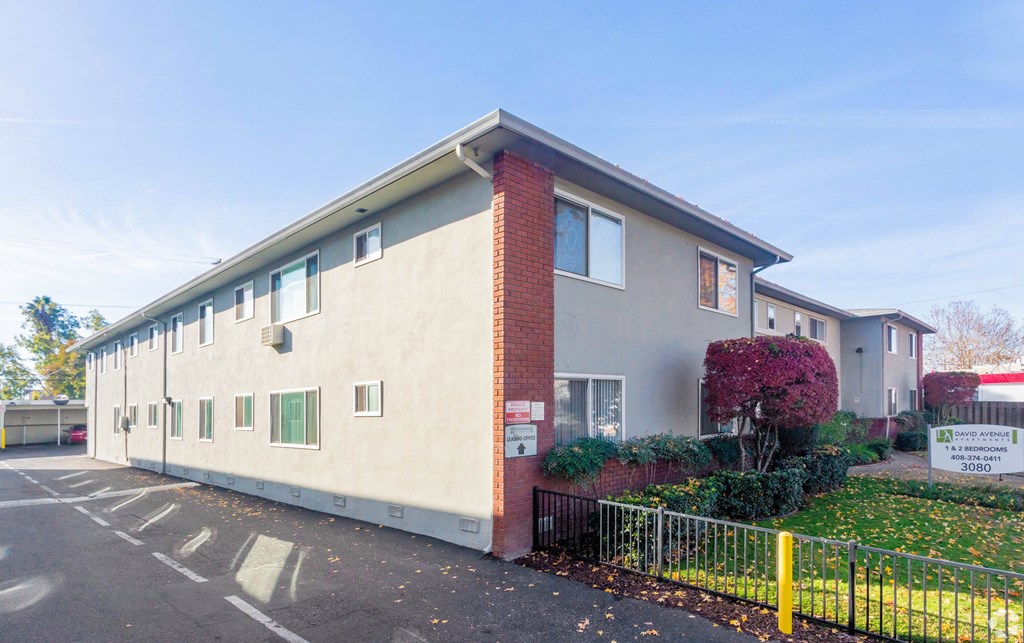 A building with a red brick chimney and a sign that says "22" on it.