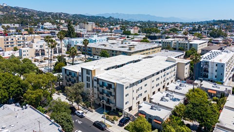 A large white building with a parking lot in front of it.