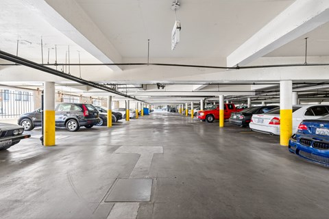 A parking garage with cars parked in yellow and blue columns.