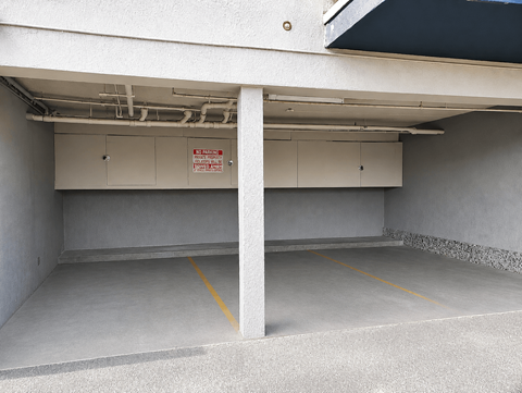 A parking garage with a no parking sign on the wall.