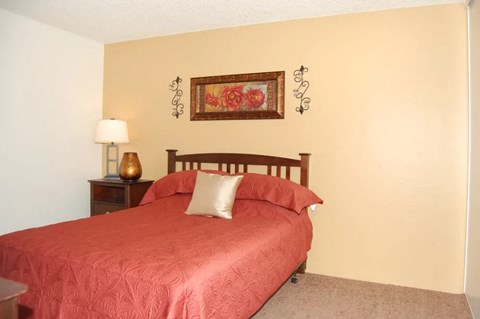 a bedroom with a bed and bedside table