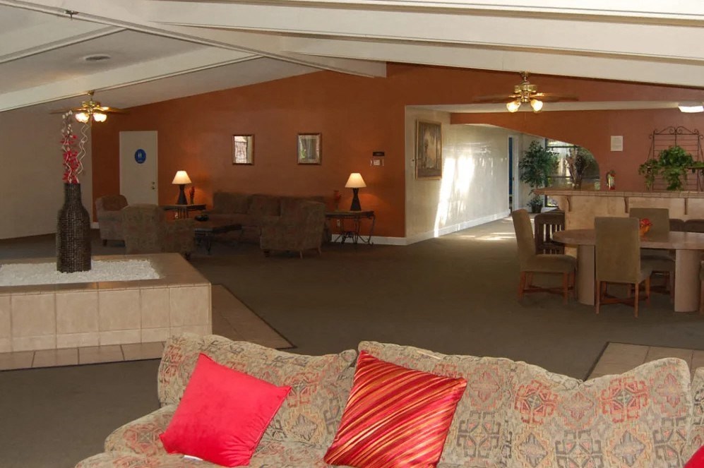 a community room with a couch and a dining room