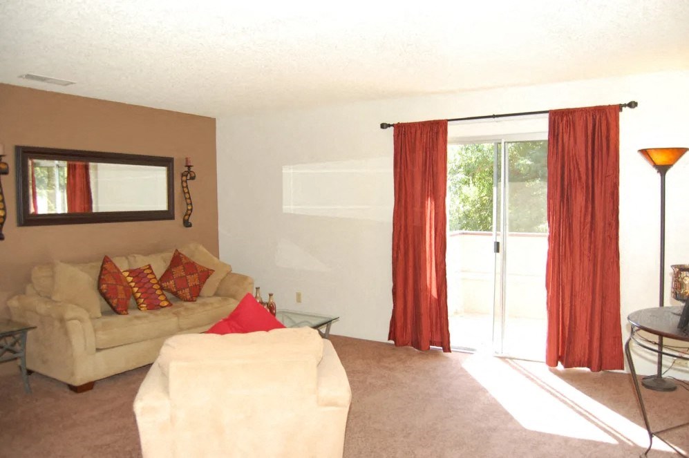 a living room with a couch and a sliding glass door
