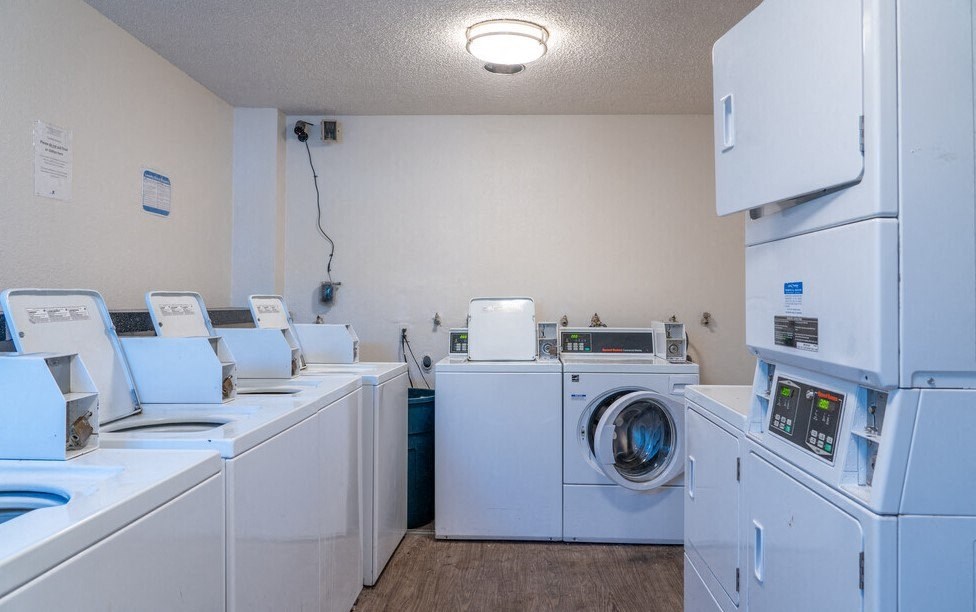 a laundry room with washer and dryers and washing machines