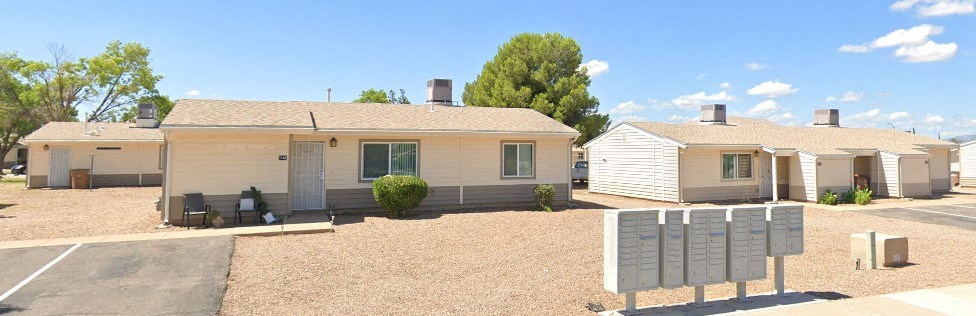 a home with a tree and blue sky in the background