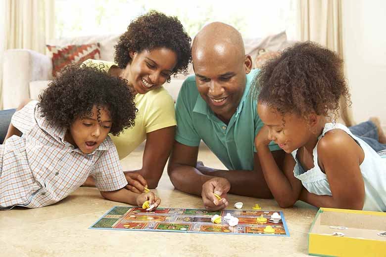 Four people playing a board game