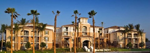 A large building with palm trees in front of it.