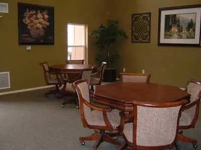 A brown wooden dining table with chairs around it.