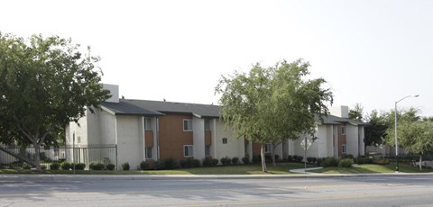 an apartment building with a street in front of it