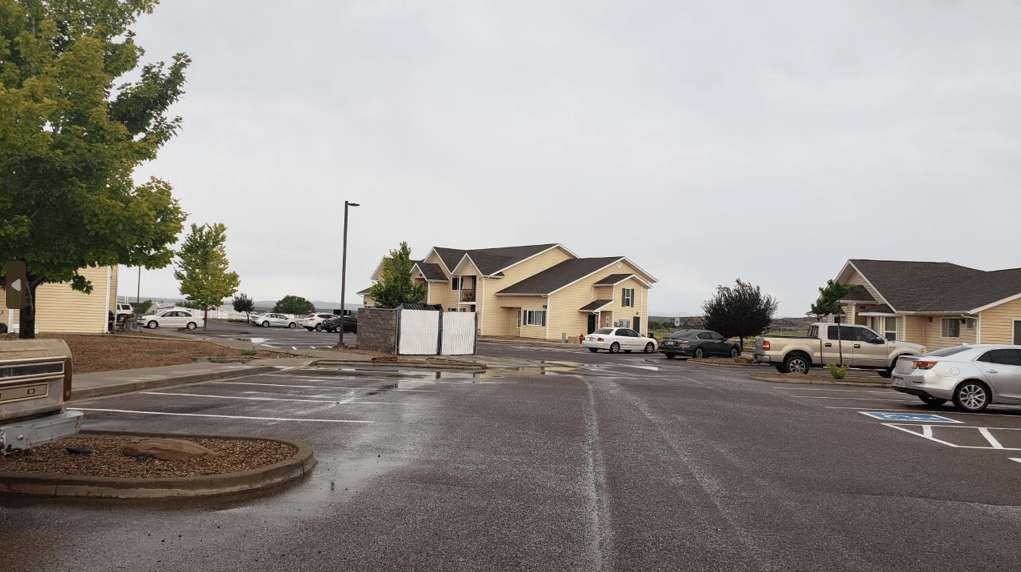 a parking lot in front of a row of houses