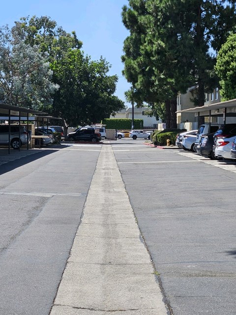 an empty parking lot with cars parked on the side