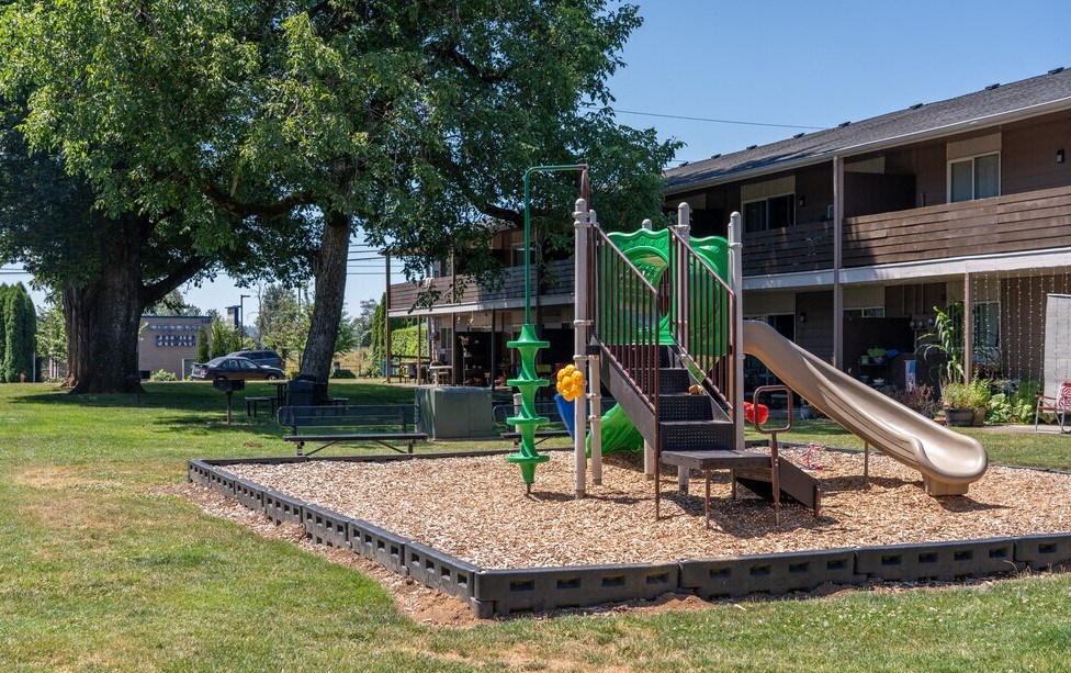 our apartments have a playground with a slide and a picnic table