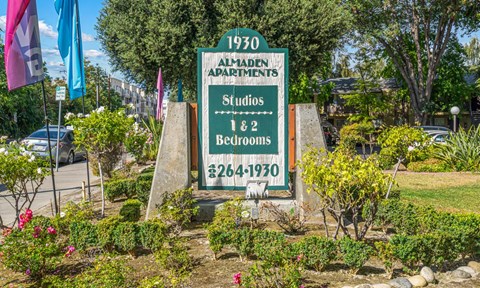 A sign for 1930 Aladen Apartments with studios and 2 bedrooms.