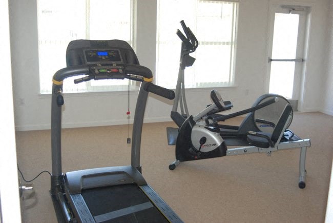 a treadmill and other exercise equipment in a gym