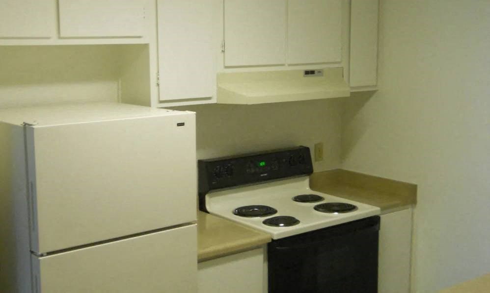 a kitchen with a stove and a refrigerator