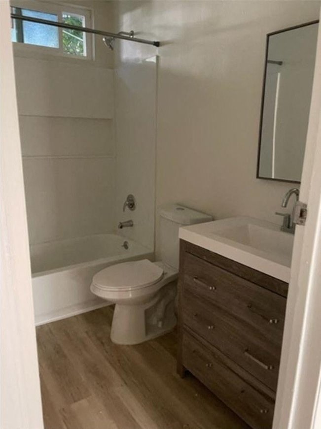 a white bathroom with a toilet and a sink