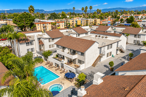 A view of a pool and apartment complex from above.