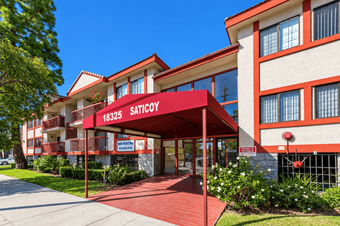 A red and white building with the sign "SATICOY" on it.
