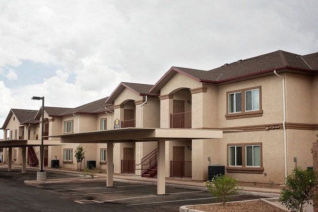 a row of houses with a street in front of them