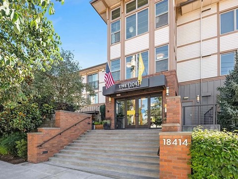 The entrance to a building with a sign that reads "The 1041" and a flag on top.