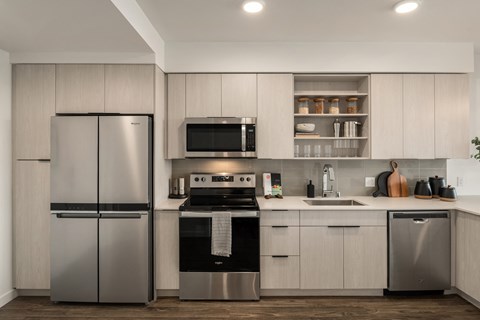 a kitchen with white cabinets and stainless steel appliances