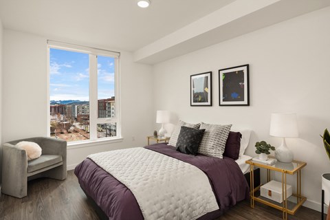 a bedroom with a large bed and a large window