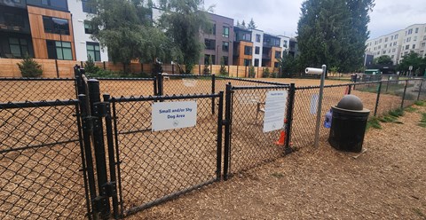 A fenced area with a sign that says Dog Area.
