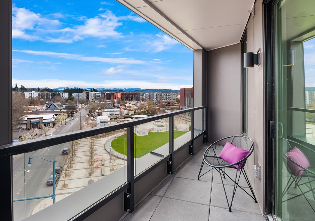 a balcony with a chair and a table