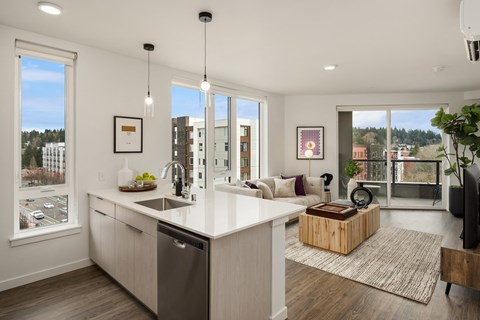 a kitchen and living room with a view of a city