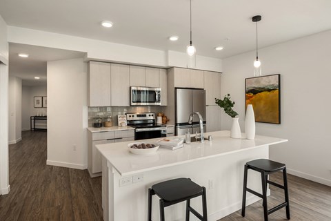a kitchen with an island and two stools