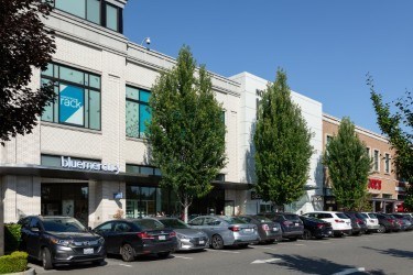 A parking lot with cars and a building with a sign that says "Blue Meridian".