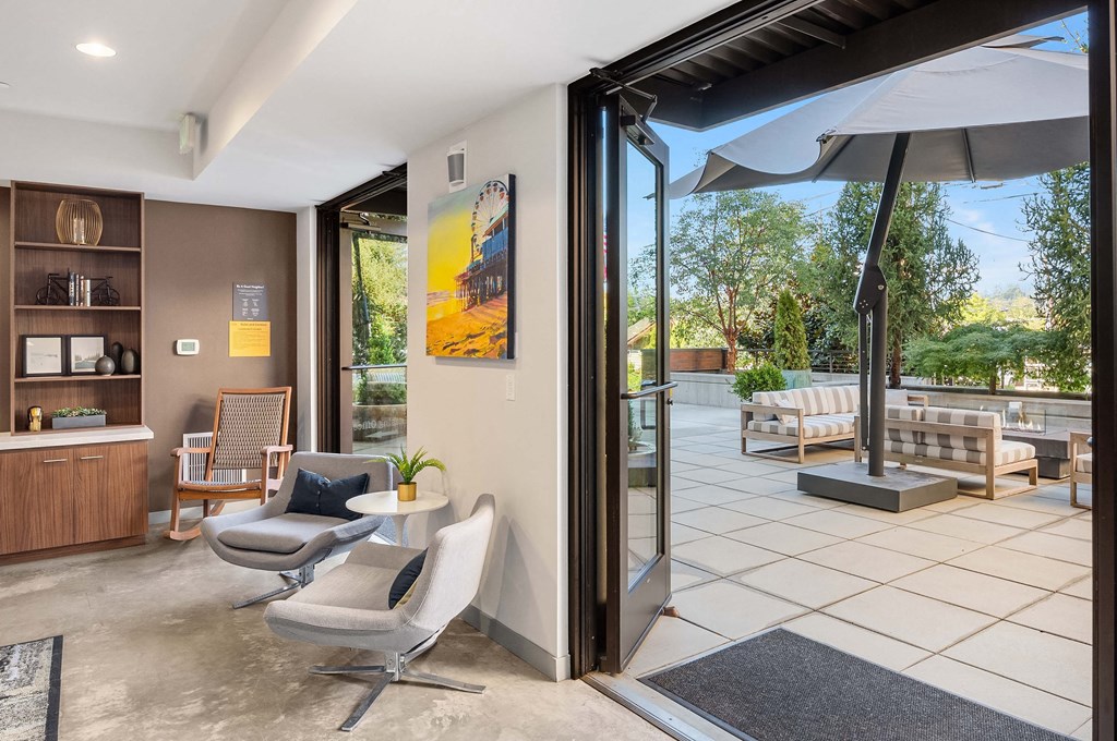 a living room with two chairs and a sliding glass door