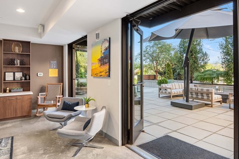 a living room with two chairs and a sliding glass door