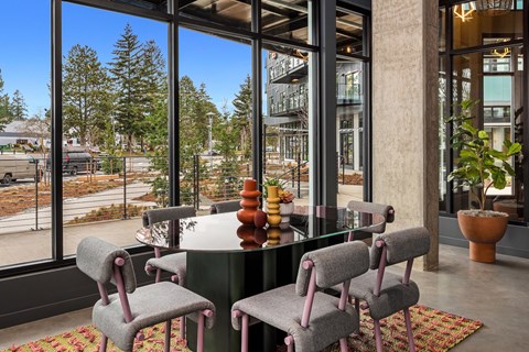 A modern dining room with a table and chairs.