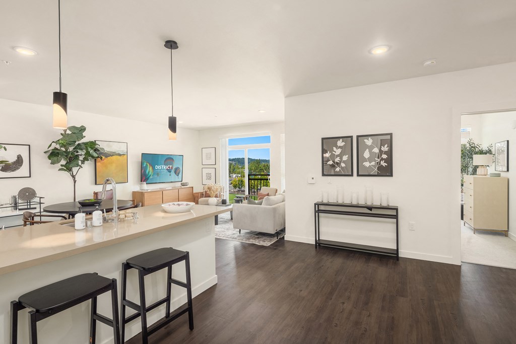 a living room with a kitchen and a dining room