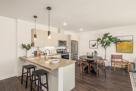 an open kitchen and dining area with a table and chairs