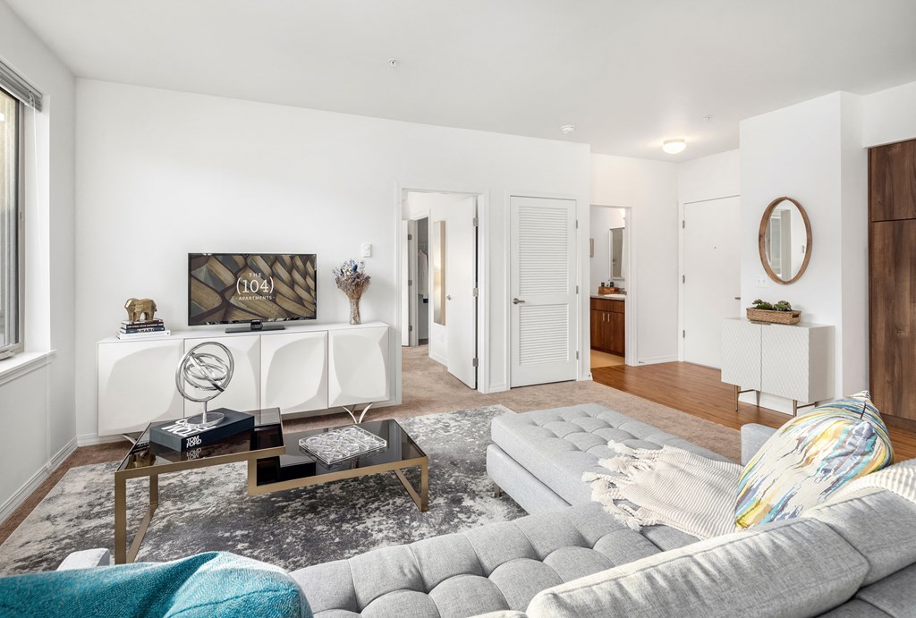 a living room with white walls and a gray couch