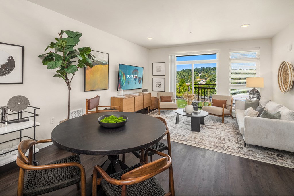 a living room with a table and chairs and a couch