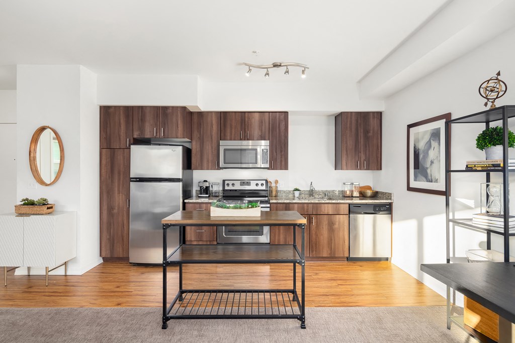 a kitchen with stainless steel appliances and wooden cabinets