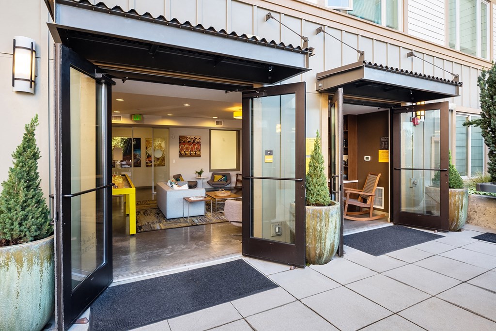 the entrance to a home with glass doors and a patio