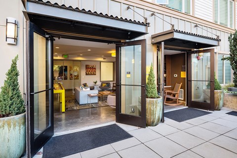 the entrance to a home with glass doors and a patio