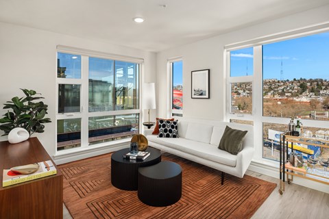 a living room with large windows and a white couch