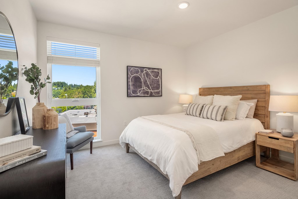 a bedroom with a large bed and a window