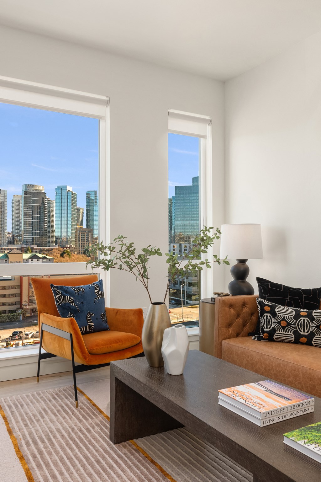 a living room with a city view and a table and chairs