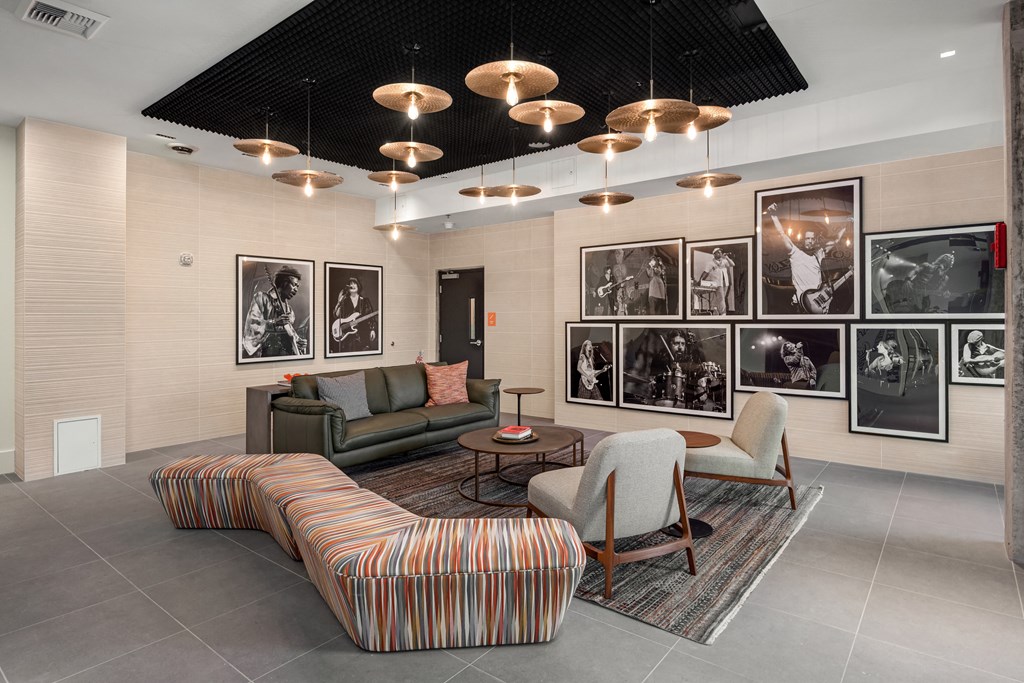 a lobby with couches chairs and pictures on the wall