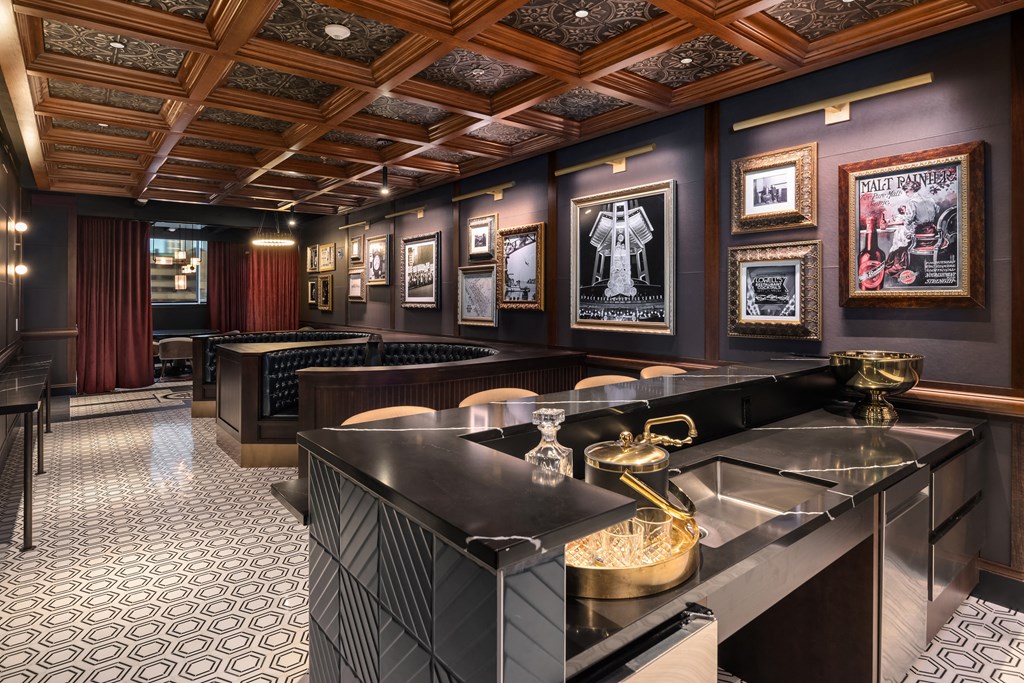 a bar with tables and chairs and pictures on the wall