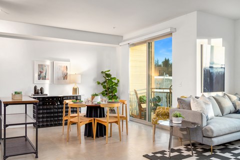 a living room with a couch and a table and a balcony