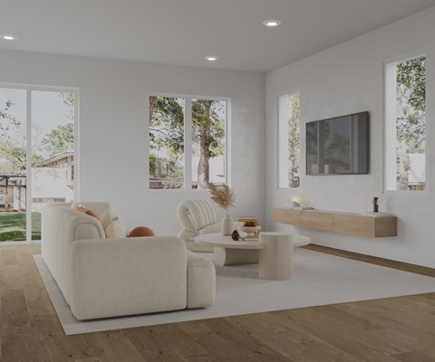 A modern living room with a white sofa and a wooden floor.
