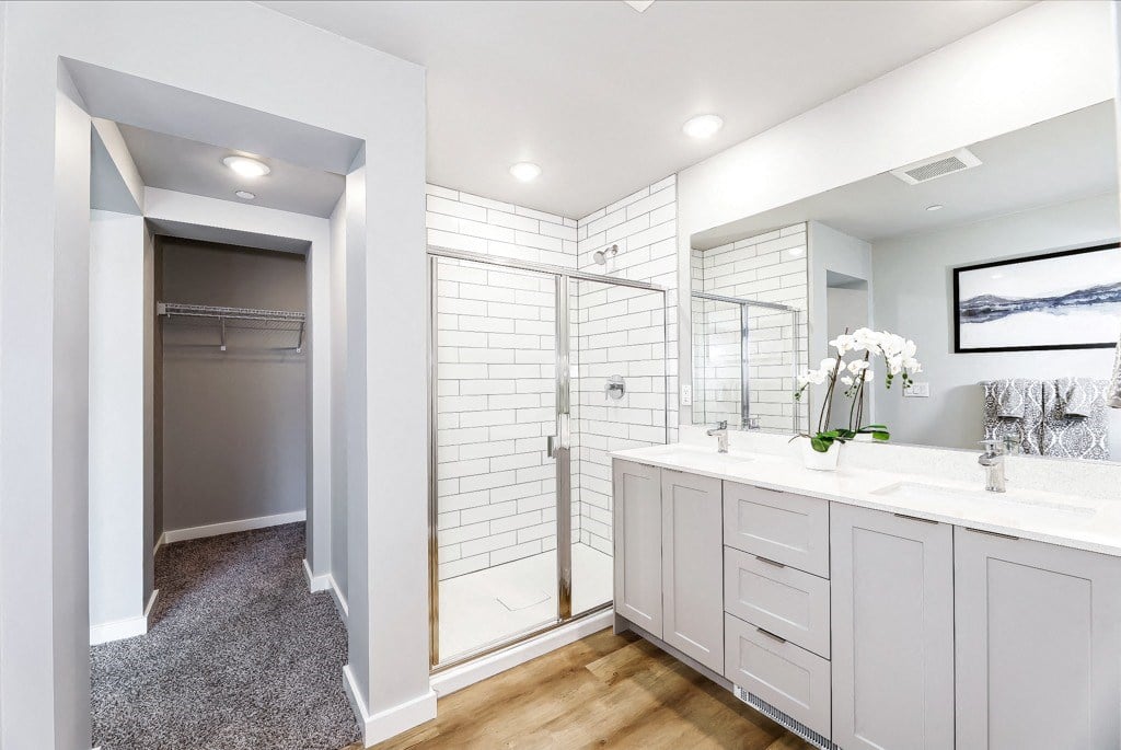 a bathroom with a large mirror and a walk in shower