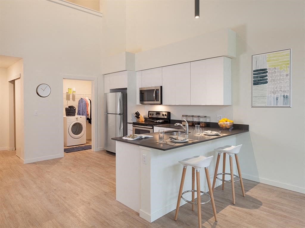 a kitchen with a counter top and stools